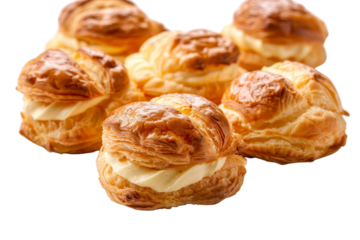 Assorted choux pastry cream puffs, or choux bread, separated on a clean white background, highlighting their golden brown color and creamy filling
