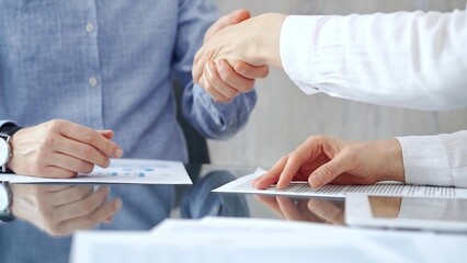 Business people shaking hands over contract agreement and financ