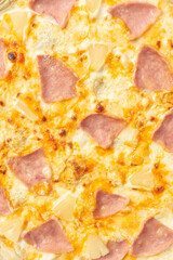 the macro composition of pizza for the menu. fresh ingredients are cheese, ham and tomatoes.