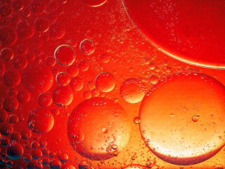 Abstract Background Red oil Macro Colorful artistic of oil drop floating on the water. macro red bubble oil of wallpeper, blood concept