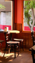 A table and chairs in a restaurant near window. Wooden table and bar stools near window. 