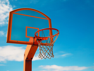 Basketball hoop set against a clear blue sky