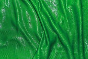 Abstract background of green fabric texture. Dimensional background and wavy surface