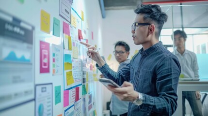Asian UX Developer and UI Designer Presenting Mobile App Interface Design on Whiteboard in Modern Office Meeting. Creative Digital Mobile App Development Agency. Digital Transformation.