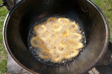 Calamari rings in deep frying in pan. Close up of frying onion rings in the fryer in hot oil.
