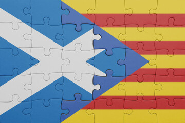 puzzle with the colourful national flag of catalonia and flag of scotland.