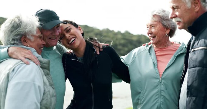 Woman, coach and hug with senior people in huddle for laughing, fitness and motivation for exercise. Scrum, support and group in nature with comic joke at training, workout and memory in retirement