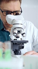 Man scientist using microscope in laboratory. Microbiology science concept
