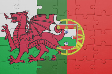 puzzle with the colourful national flag of portugal and flag of wales .