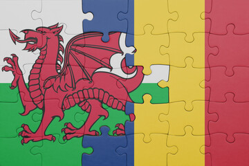 puzzle with the colourful national flag of romania and flag of wales .