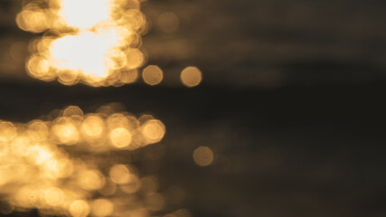 blurred background, sunset or sunrise on the sea, a path of light on the water, highlights and bokeh in blur