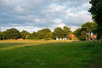 Green fields and houses at the German countryside in Heidenau, Lower Saxony, Germany