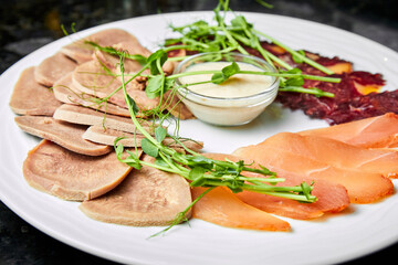 Assorted meats of makhan, chicken balyk and beef tongue with creamy sauce