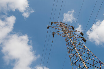 Power pylons and high-voltage lines against the background of the cloudy sky, power lines.