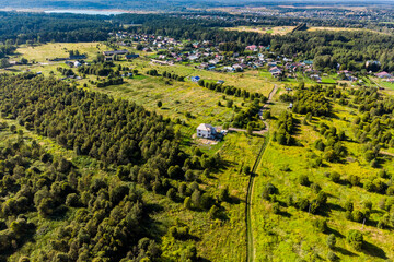 Aerial view of village outskirts in scenic flat area, suburban real estate construction