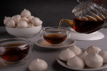 meringue, teapot, sweets, tea, enjoying, teacup, plate, cookie, setting, dark, transparent, partially, filled, cozy, ambiance, decor, suitable, sugar, small, white, ceramic