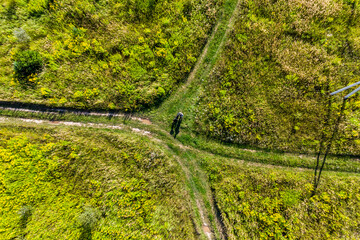 Crossroads of dirt roads in a field, aerial view. Choosing a direction on a trip