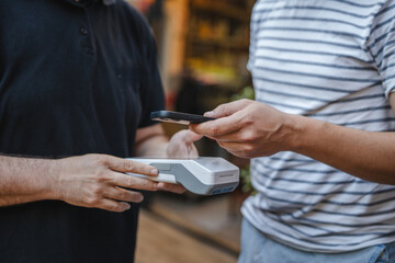 Unknown adult man have contactless payment with credit card