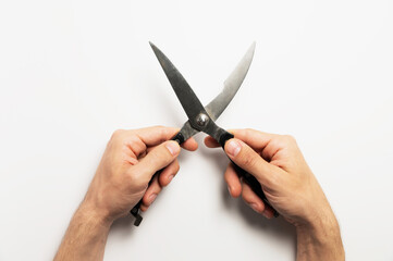 Worker holding pruning shears by handles on white background, close-up. Garden tool