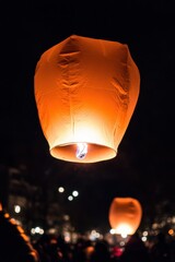 Lantern floating in the night sky during a festival