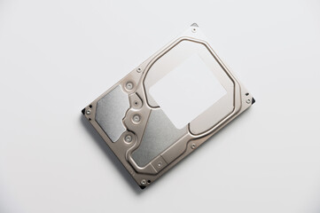 A 3.5 size hard drive with blank brand stickers lies on a white background