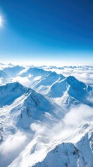 Obraz premium An aerial view of a mountain range with snow-capped peaks, deep valleys, and clouds drifting over the landscape, creating a majestic and awe-inspiring scene