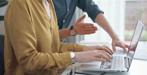 Team collaboration over financial reports. Business people, professionals analyzing financial charts and data on a desk while sitting near a laptop computer