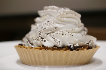 pie slice with cream on top on a plate