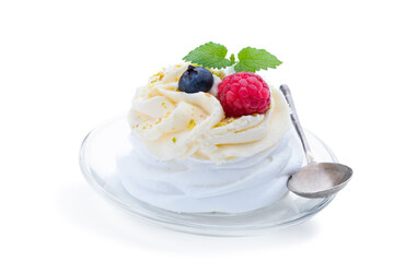 Mini Pavlova meringue nest with berries and whipped cream isolated on white