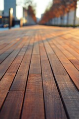 Fototapeta premium Wood decking pathway illuminated by sunset in an urban park