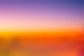 Obraz premium Gradient background: Sunset Symphony: beauty of a digital sunset in this mesmerizing gradient. The seamless transition from deep purple to vibrant orange and soft pink evokes tranquility and wonder