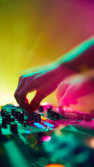 DJ, bathed in colorful light, creates electric atmosphere, his every move synchronized with beats...