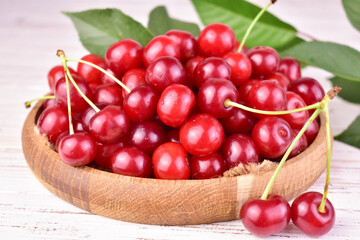 Ripe red cherry in a wooden pot.Close-up.
