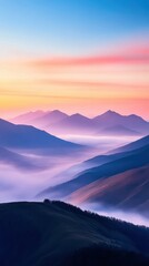 Fototapeta premium A mountain range at dawn, with mist rising from the valleys and the first light hitting the peaks