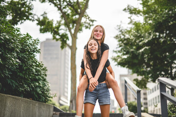 Obraz premium young girlfriend standing at city street. Outside portrait of joyful beautiful teen over urban background.