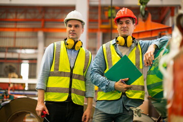 Engineer working team service and discussing plan of maintenance machine in heavy industrial factory