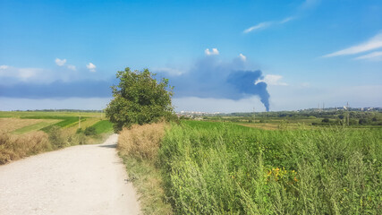 Column of black smoke from a fire over the city