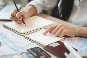 person planning vacation trip to overseas checking tourist destination guide on the map, prepare...