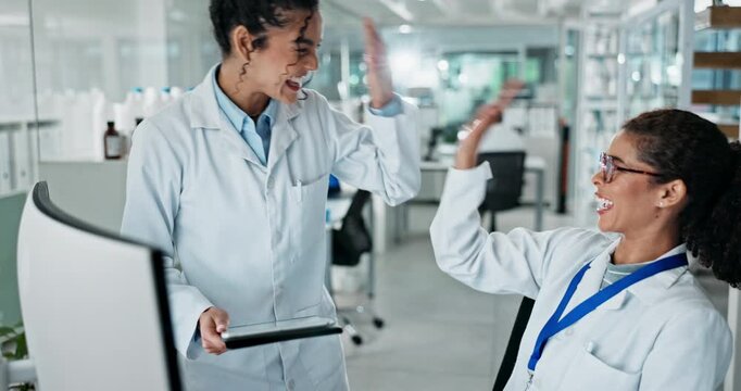 Science, women and high five with tablet in lab for success of medical research, project management and procedure. Female scientists, technology and breakthrough for cancer immunotherapy study.