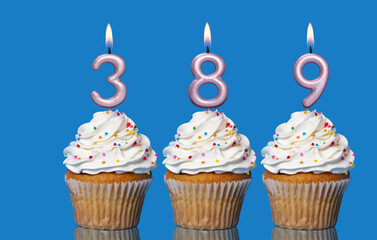 Birthday Cupcakes With Candles Lit Forming The Number 389