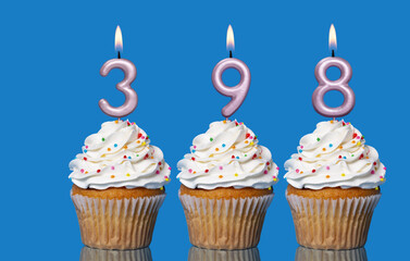 Birthday Cupcakes With Candles Lit Forming The Number 398