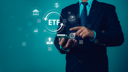 Man use smartphone to analyze and manage ETF account online. Represents investment growth and shows icons of ETF Exchange traded fund stock market trading investment financial concept.