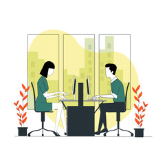 A man and woman sitting at a desk with two computers.