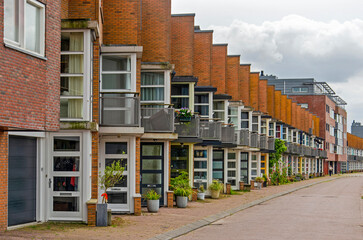 Lelystad, The Netherlands, August 4, 2024: sawtooth facade of row housing overlooking lake Markermeer