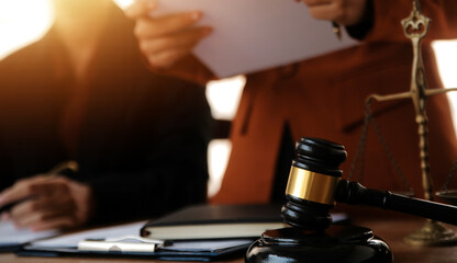 Lawyer, legal advisor, businessman brainstorming information on agreement details Business contracts in legal processing books for accuracy in contract documents. joint financial investment.