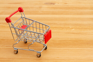 Red shopping cart with on a desk