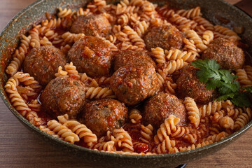 minced meat meatballs, in tomato sauce, with fusilli pasta, in a cast-iron pan, homemade, no people,