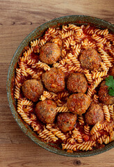 minced meat meatballs, in tomato sauce, with fusilli pasta, in a cast-iron pan, homemade, no people,