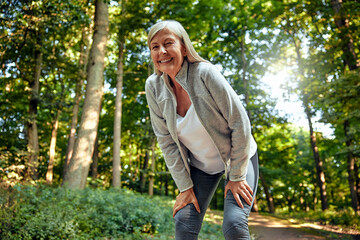 An Exhausted Woman Taking a Welldeserved Break in the Beautiful Nature During Outdoor Exercise