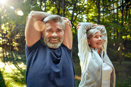 Outdoor Fitness Active Seniors Engaging in Stretching Exercises in Beautiful Nature